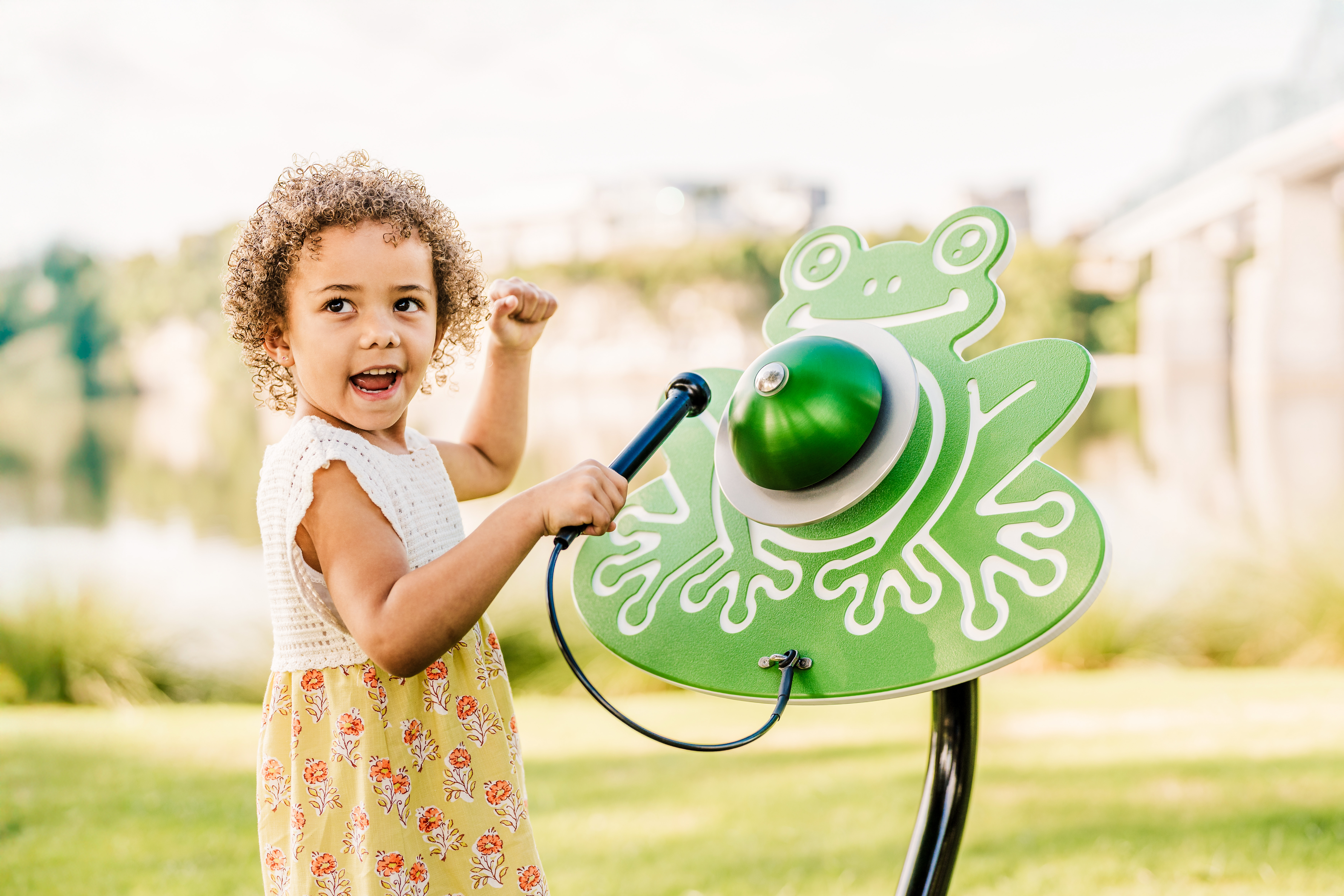 Girl in yellow dress playing Ribbity Bell happily