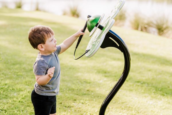 Boy playing ribbity bell instrument