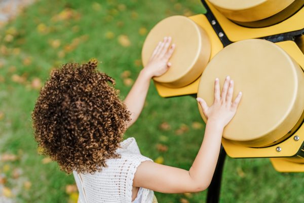 Girl playing Honeycomb congas