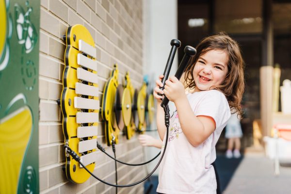 Girl holding mallets playing Hive